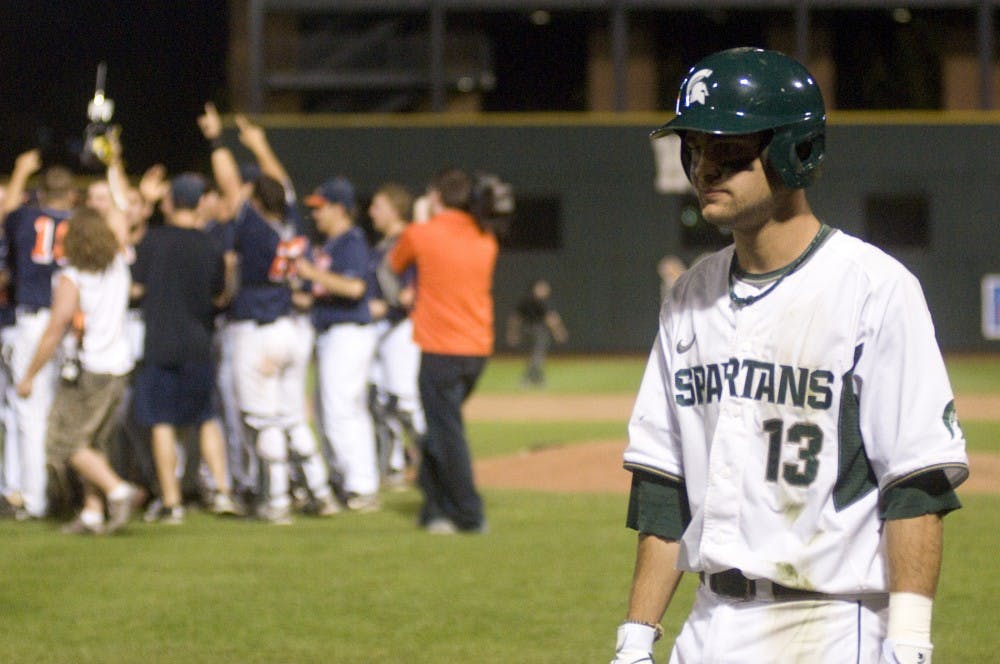 	<p>Junior shortstop Justin Scanlon walks past Illinois players as they celebrate their win Saturday at Huntington Park in Columbus, Ohio. Scanlon&#8217;s fly ball was caught, giving <span class="caps">MSU</span> their third out and ending the Big Ten Tournament Championship game with a final score of 9-1. Kat Petersen/The State News</p>
