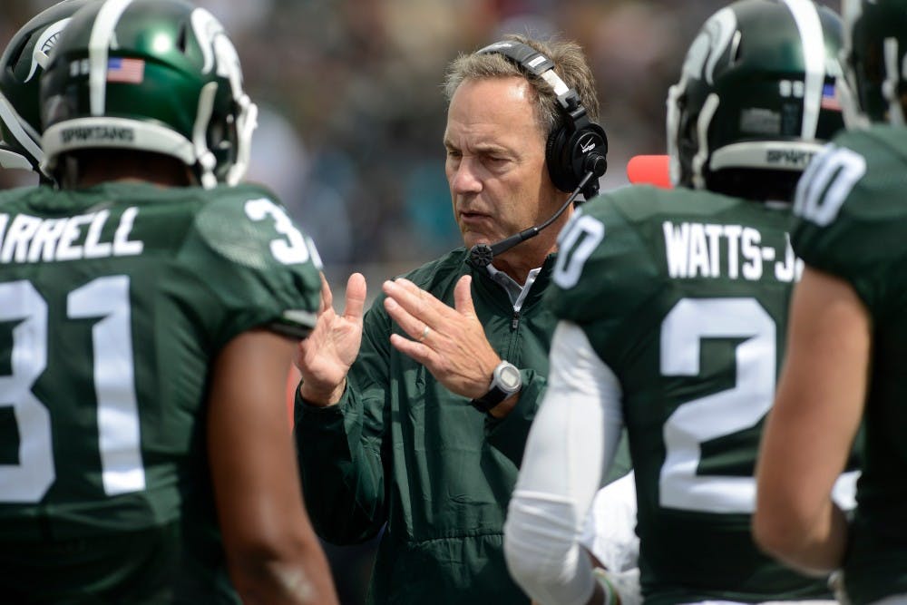 <p>Head coach Mark Dantonio talks to his team in the second quarter during a game against Air Force on Sept. 19, 2015, at Spartan Stadium. The Spartans defeated the Falcons, 35-21. Julia Nagy/The State News</p>