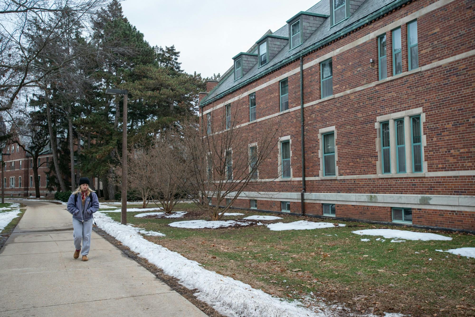 <p>A student walks past Mason Hall on Jan. 27, 2020.</p>