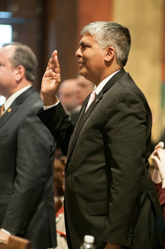 <p>State Representative Sam Singh takes the oath Jan.14, 2015, during the opening session of the House and Senate at the Capitol Building. Singh was appointed for the first time as Minority Floor Leader. Kelsey Feldpausch/The State News.</p>