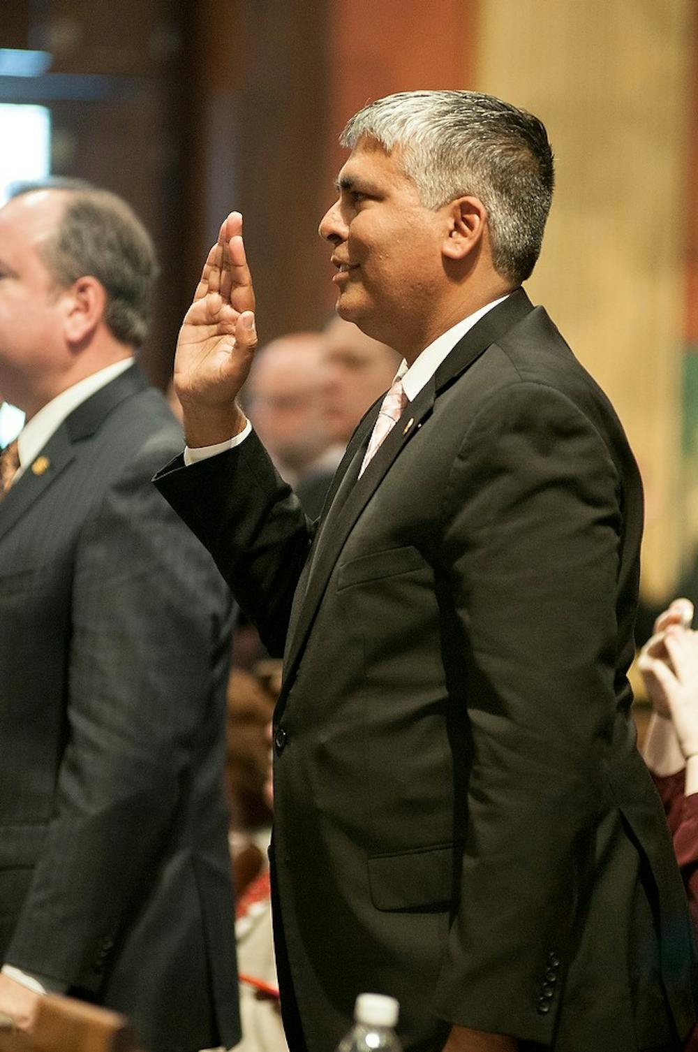 <p>State Representative Sam Singh takes the oath Jan.14, 2015, during the opening session of the House and Senate at the Capitol Building. Singh was appointed for the first time as Minority Floor Leader. Kelsey Feldpausch/The State News.</p>