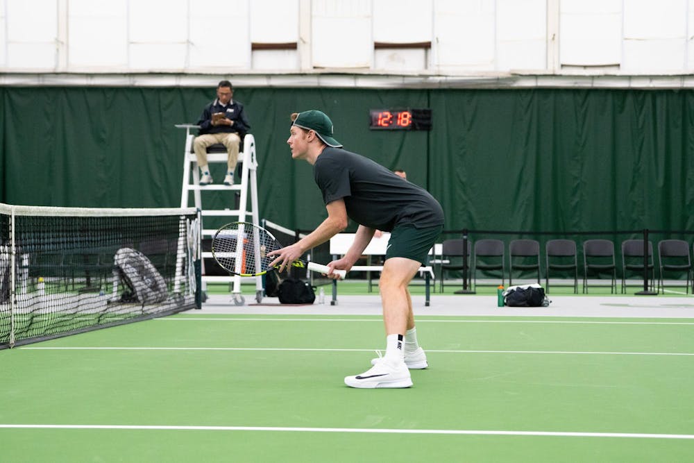<p>Senior Max Sheldon in a singles match against a University of Michigan player on April 19, 2025. Sheldon was honored for Senior Day moments later.</p>