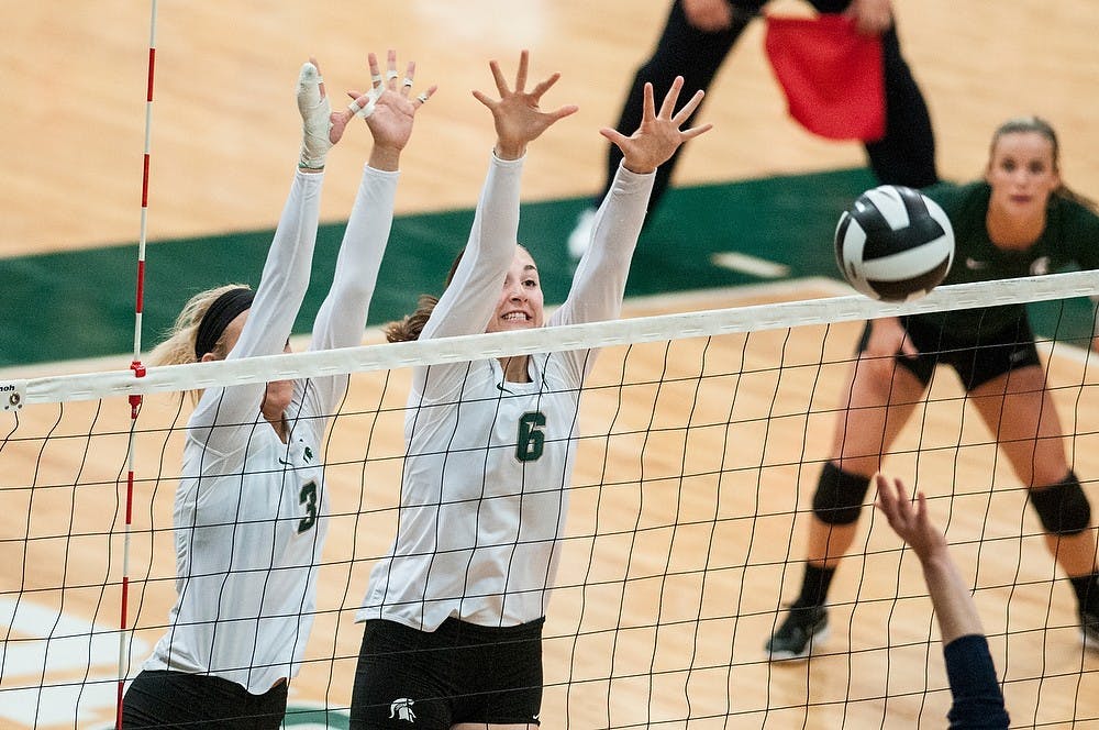 	<p>Freshman middle blocker Autumn Christenson, left, and freshman middle blocker Allyssah Fitterer, right, go up for a block during the game against Michigan on Oct. 23, 2013, at Jenison Field House. The Spartans fell to the Wolverines, 3-1. Khoa Nguyen/The State News</p>