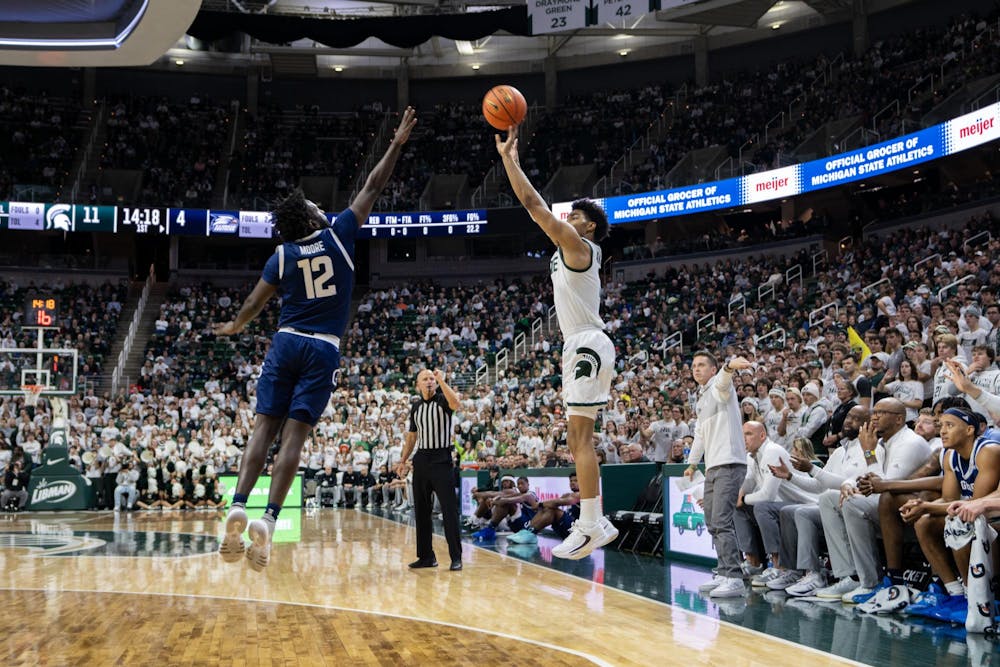 <p>MSU Junior Guard Jaden Akins (3) fires off a leaping shot over the reaching Georgia Southern defender Senior Guard Tyren Moore at the Jack Breslin Student Events Center, on Nov 28, 2023.</p>