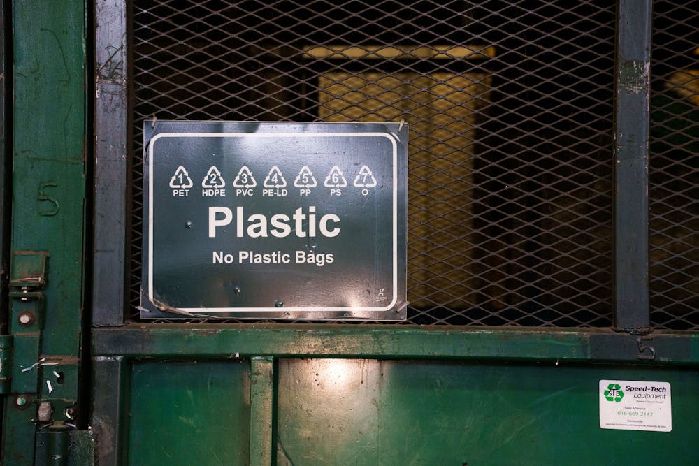 A sign in the MSU Recycling Center labels collection point for plastic goods, soon to be turned into bales and sold to be processed, photographed on April 3, 2023.