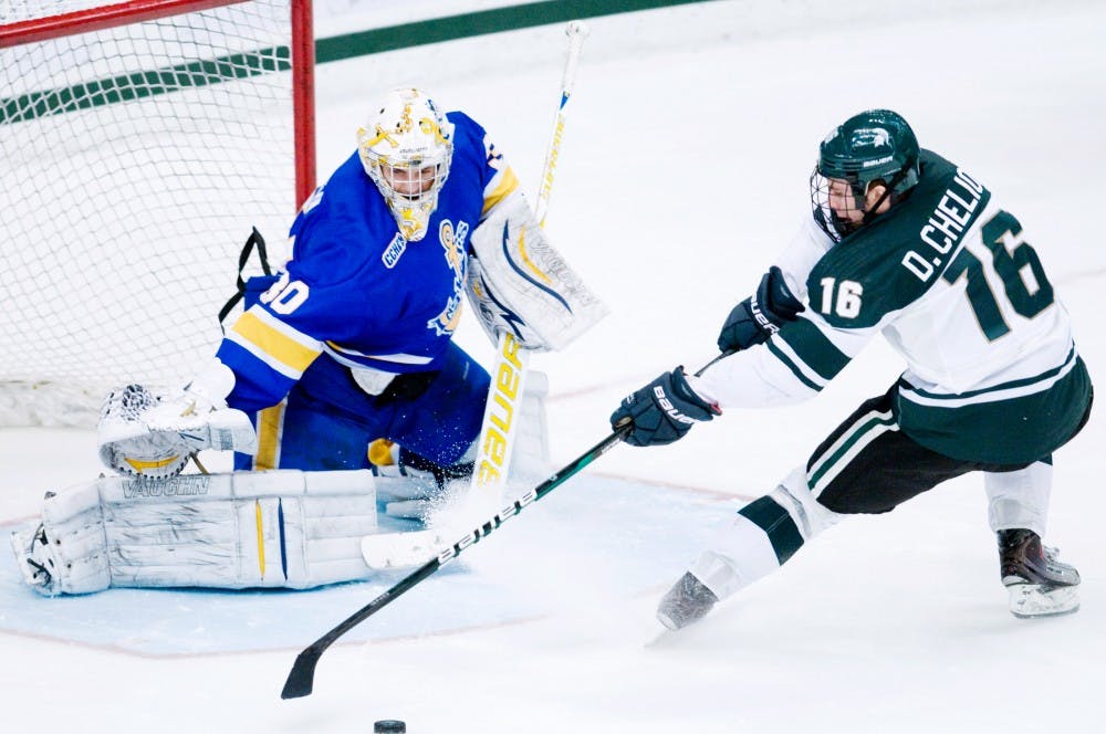 Junior left winger Dean Chelios tries to deke the goaltender Kevin Kapalka in a thrilling overtime shootout Saturday night at Munn Ice Arena. Lake State Superior would go on to win after one overtime and a shootout.Aaron Snyder/The State News 