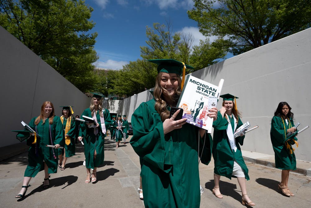 Graduates walk out of the Breslin Center tunnel after commencements on May 3, 2025.