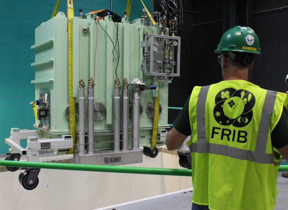 FRIB Project personnel place a cryomodule in the linear accelerator tunnel on July 17, 2017.  Photo courtesy of the National Superconducting Cyclotron Laboratory.