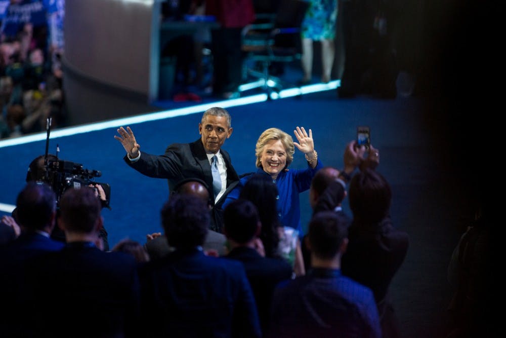President Barack Obama and democratic presidential nominee Hillary Clinton wave to the crowd on July 27, 2016, the third day of the Democratic National Convention, at Wells Fargo Arena in Philadelphia.