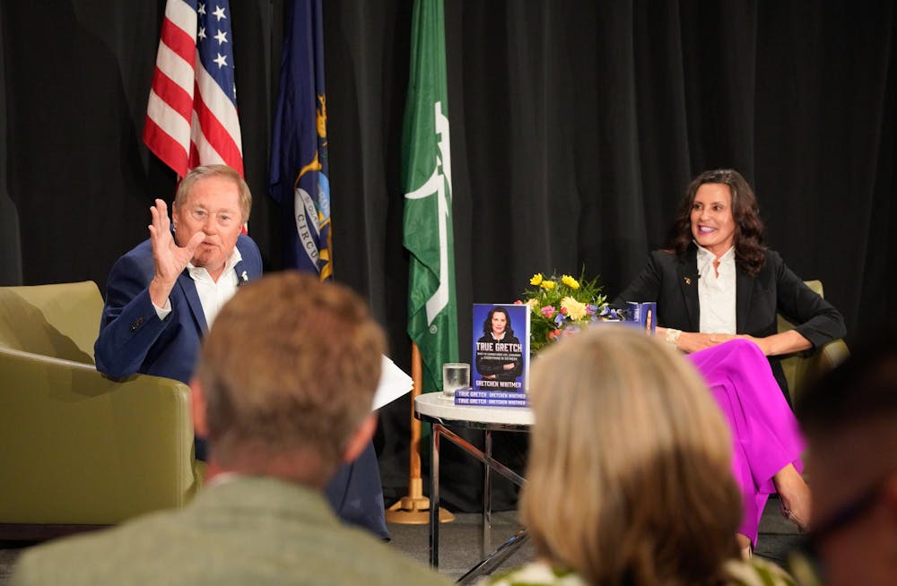 Former Gov. James Blanchard and Gov. Gretchen Whitmer speak to MSU President Kevin Guskiewicz in the crowd on July 23, 2024. 