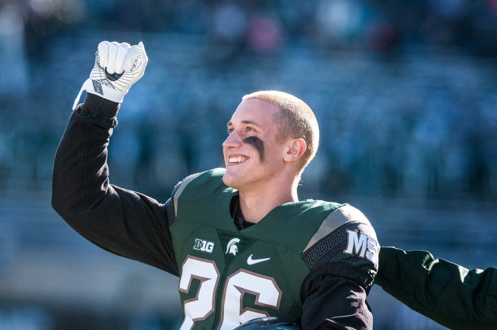 Junior wide receiver Austin Wolfe (26) is honored with his father Christopher Wolfe who served in the U.S Army for 29 years during the game against Rutgers on Nov. 19, 2016 at Spartan Stadium. Austin is also currently in ROTC.