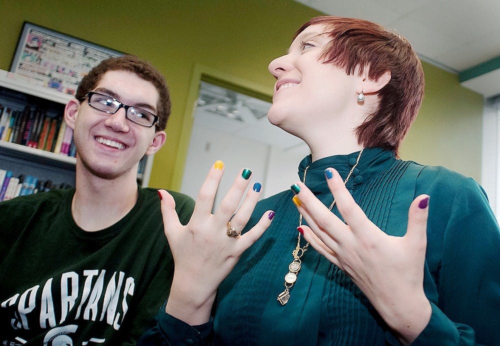 	<p>Professional writing and women&#8217;s studies senior Allegra Smith, right, talks with genetics freshman Colin Wiebrecht about the upcoming <span class="caps">MBLGTACC</span> conference on Thursday at the <span class="caps">LGBT</span> Resource Center. Katie Stiefel/The State News</p>