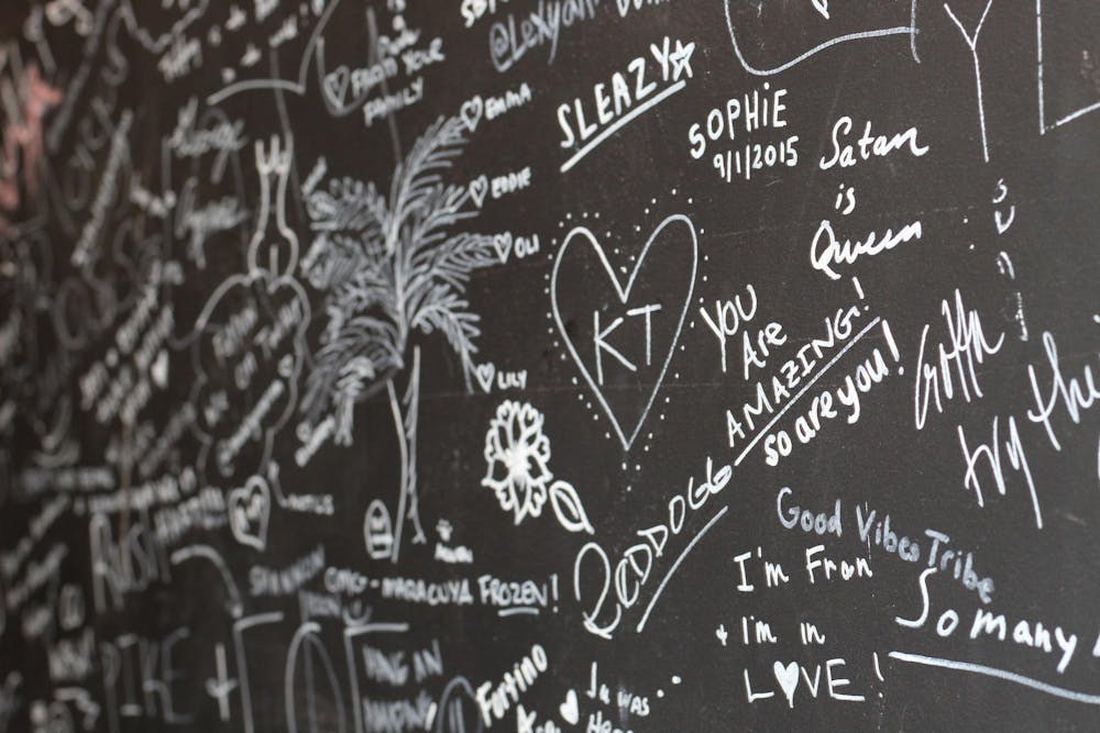 <p>Handie owner Taiwo Adeleye has customers sign the store wall when inside the restaurant. The grand opening of Handie’s new location is on Oct. 24th, 2024.</p>