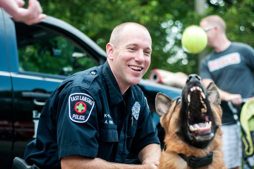 	<p>East Lansing police department K-9 officer Adam Park watches as his dog Max catches a tennis ball, during the National Night Out/Touch-A-Truck event, August 6, 2013, outside the East Lansing Public Library, 950 Abbot road. Max, now 7, has been with Park for about five years. Danyelle Morrow/The State News</p>