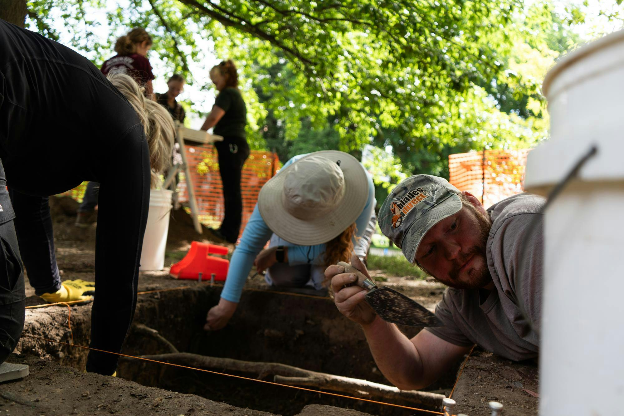 <p>Andrew Kracinski (right) and other members of the Campus Archaeology Program work on excavating the old observatory site in East Lansing, Mich., on June 15, 2026.</p>
