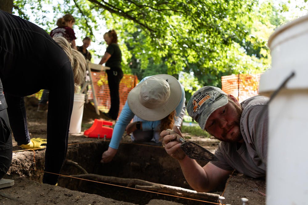 <p>Andrew Kracinski (right) and other members of the Campus Archaeology Program work on excavating the old observatory site in East Lansing, Mich., on June 15, 2026.</p>