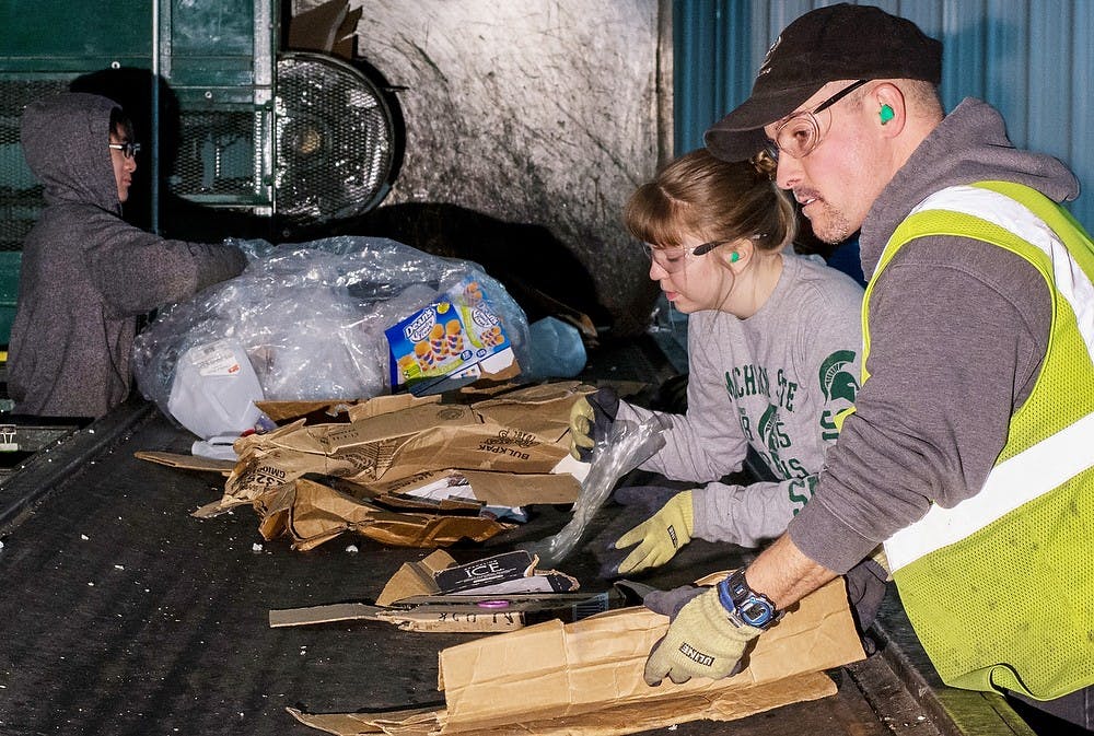 	<p>Dewitt Charter Township, Mich., resident and short-line specialist Nick Kwieck, right and political science sophomore Becky Dumbleton work at the <span class="caps">MSU</span> Recycling Center on Feb. 3, 2014. The <span class="caps">MSU</span> Recycling Center is the local facility participating in Recyclemania, a competition for universities and communities that lasts until March 31. Casey Hull/The State News</p>