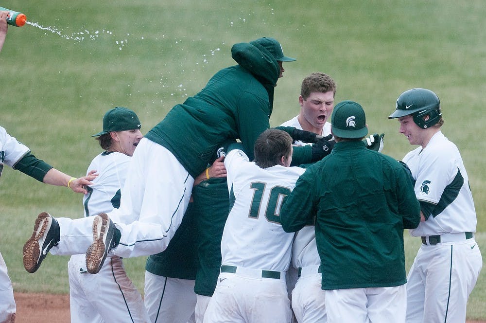 	<p>The Spartans celebrate April 12, 2013, after the first game of a three game series against Indiana at McLane Baseball Stadium at Old College Field. The Spartans defeated the Hoosiers, 2-1, in the first game of the series. Julia Nagy/The State News</p>