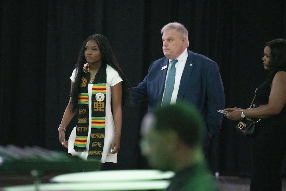 Arielle Anderson’s sister accepts her posthumous degree at The College of Natural Science graduate ceremony alongside Alexandria Verner’s godmother on Saturday, May 6, 2023 at the Breslin Center.