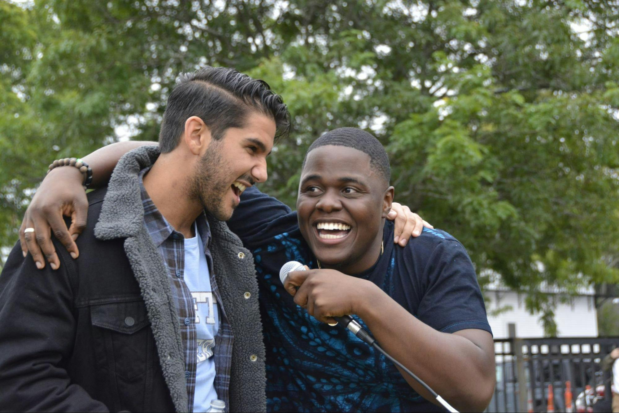 Ayo Oloyede, lead vocalist of Free Money, singing in the crowd with an audience member.