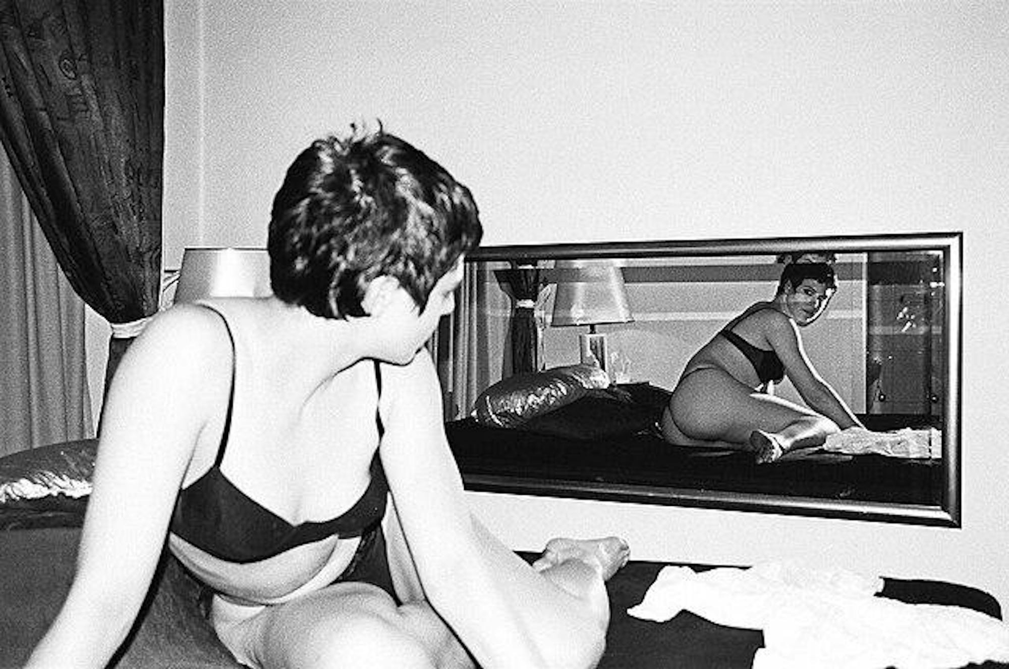 Woman_lying_on_bed,_looking_at_mirror,_Berlin_2001.jpg