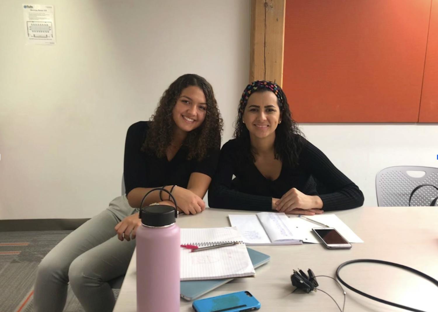 Elise Webster, a Tufts student who graduated in 2022, is seated next to her Portuguese-speaking learner Regiane at Potencia.