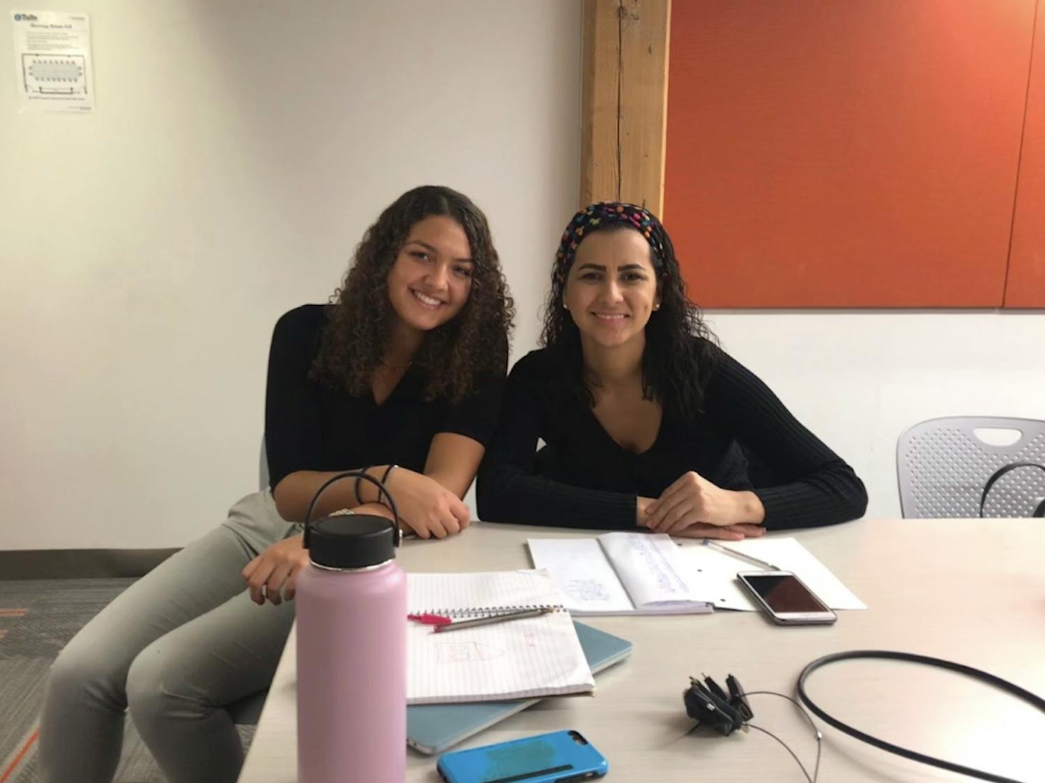 Elise Webster, a Tufts student who graduated in 2022, is seated next to her Portuguese-speaking learner Regiane at Potencia.