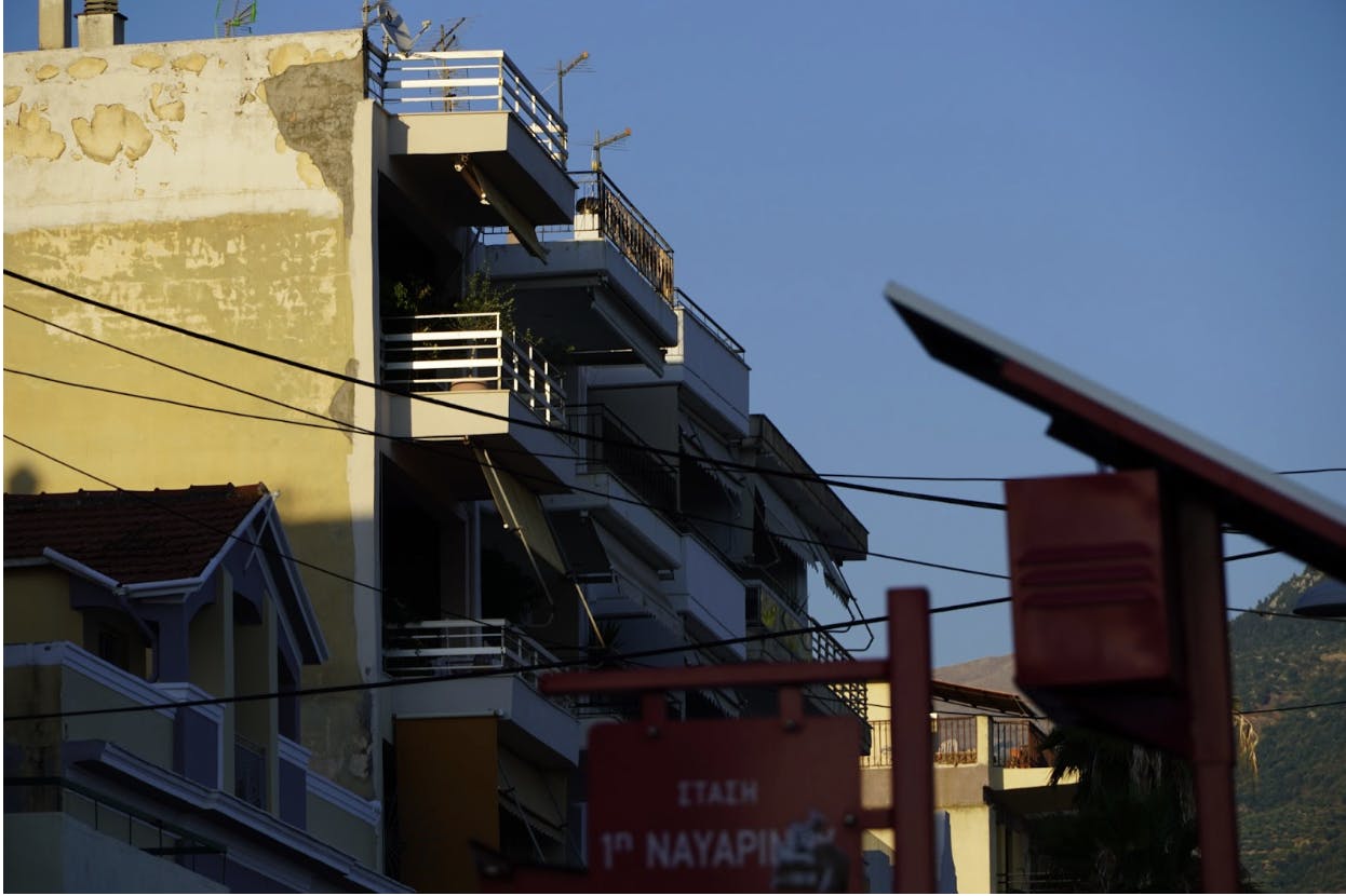 Apartment buildings next to the bus stop on Navarino Street in the valley between the mountains.