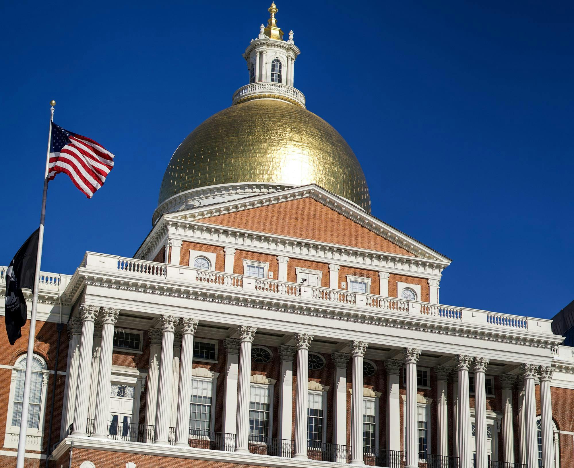 The Massachusetts State House stands next to Boston Common.