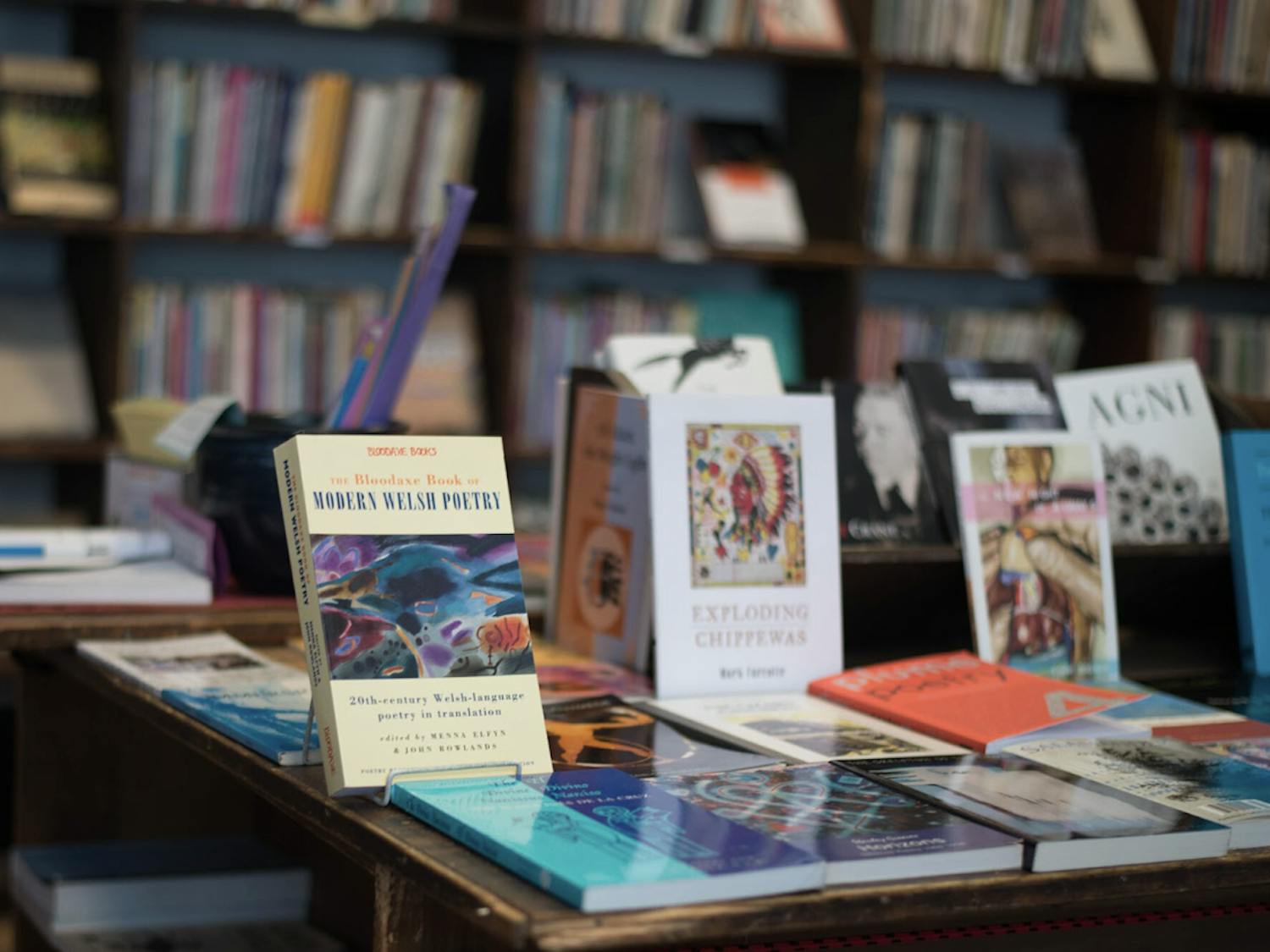 Books displayed on a table at Grolier Poetry Book Shop.