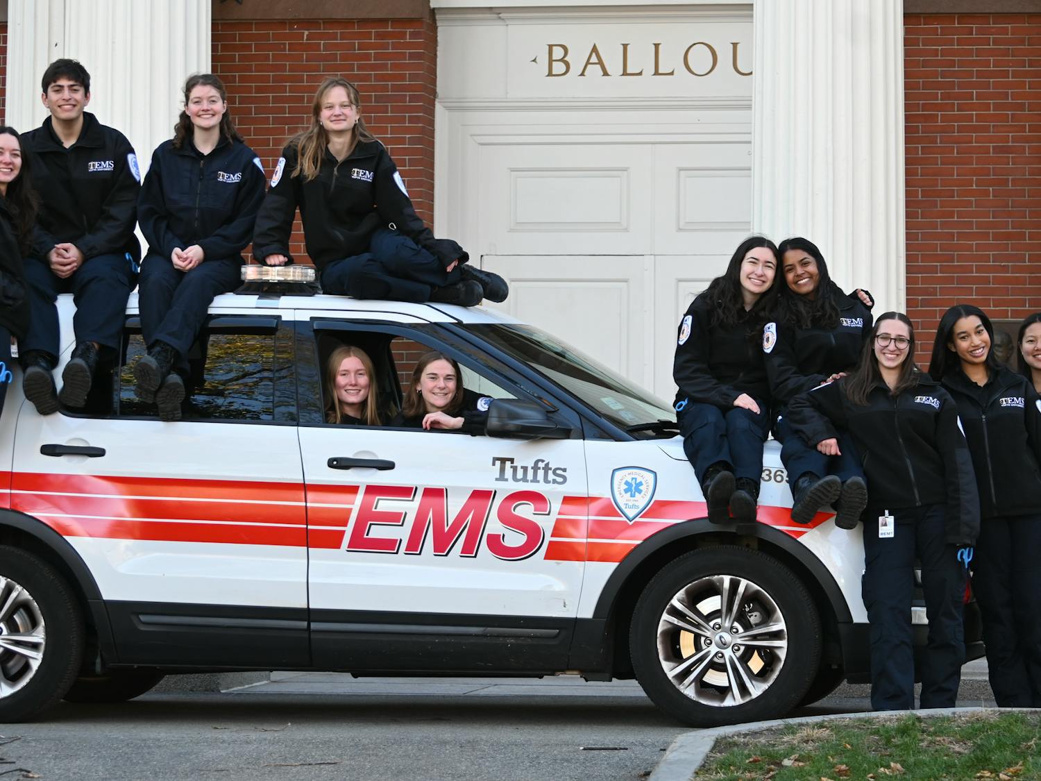 Members of the TEMS team are pictured around a TEMS car.