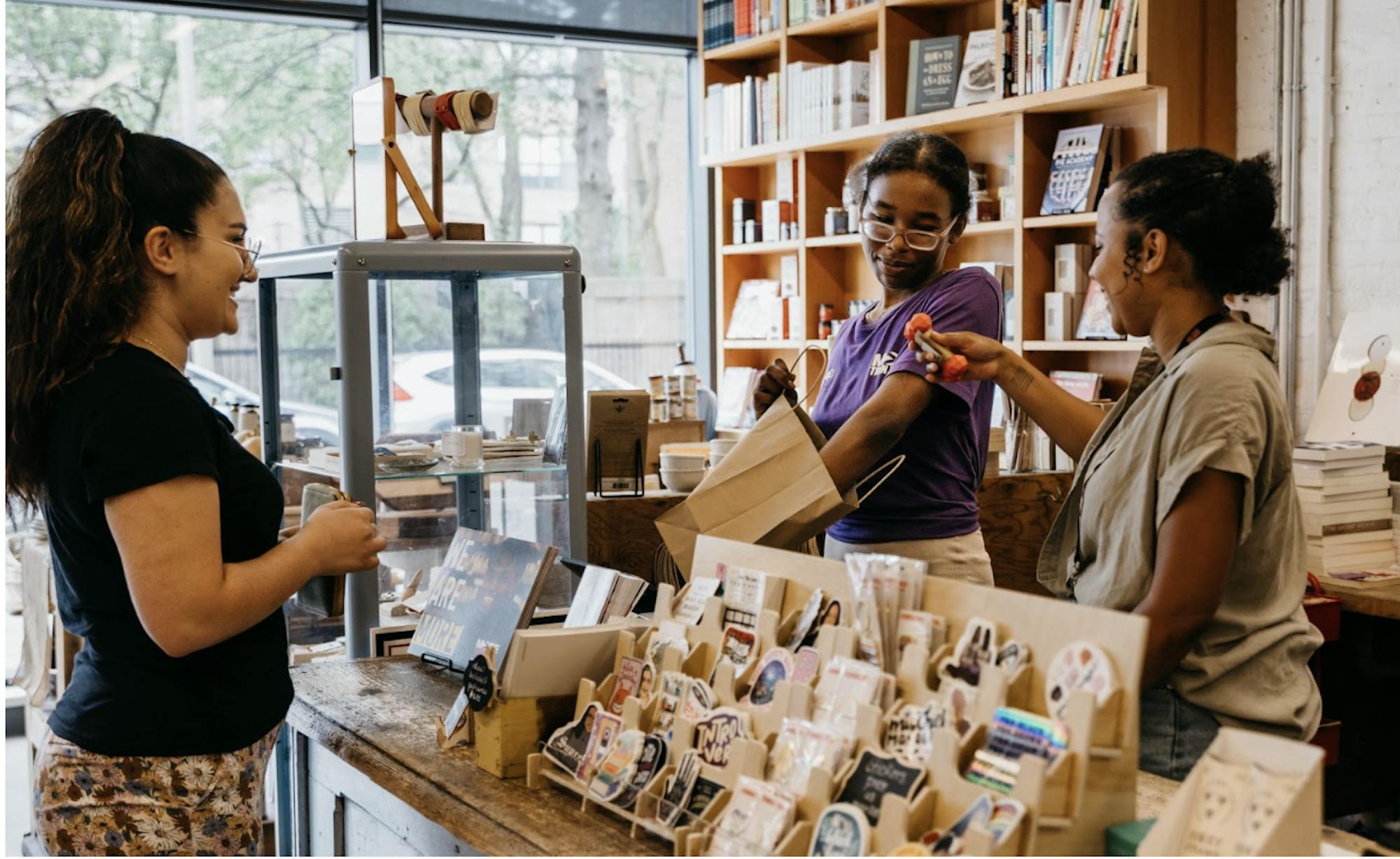 A customer and employees pictured in the bookstore.