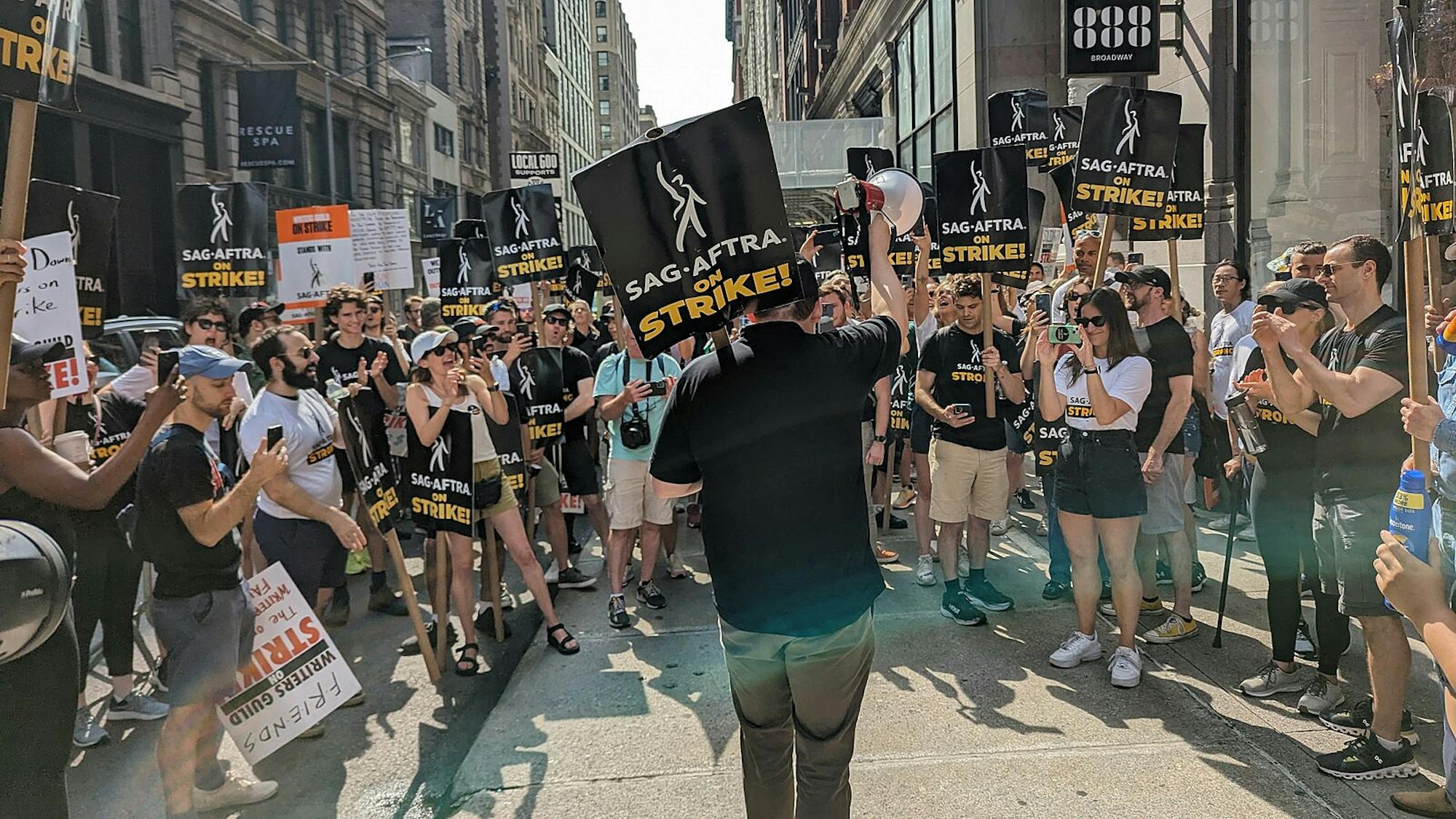 Members of SAG-AFTRA are joined by members of the WGA in a picket rally against the AMPTP on July 20, 2023.