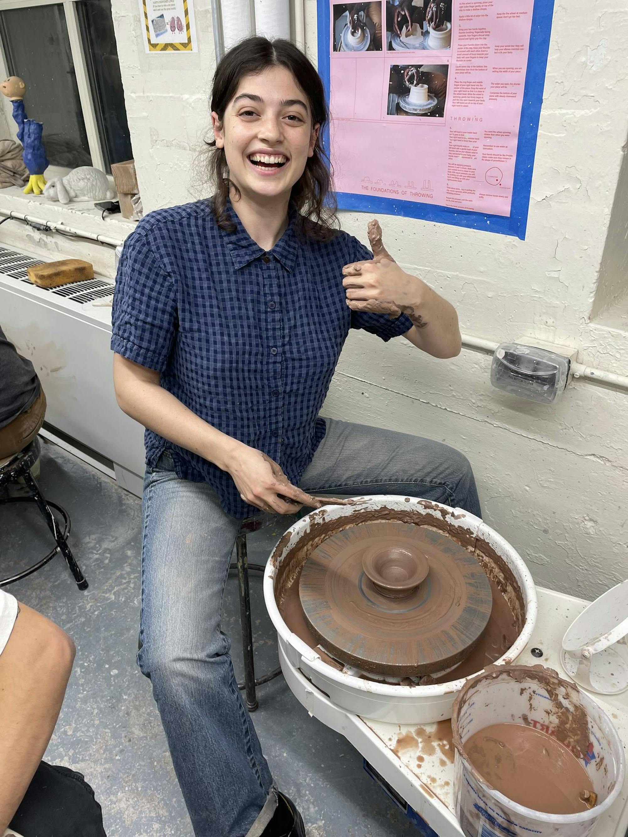 A Clay Club member is pictured at a potter's wheel.