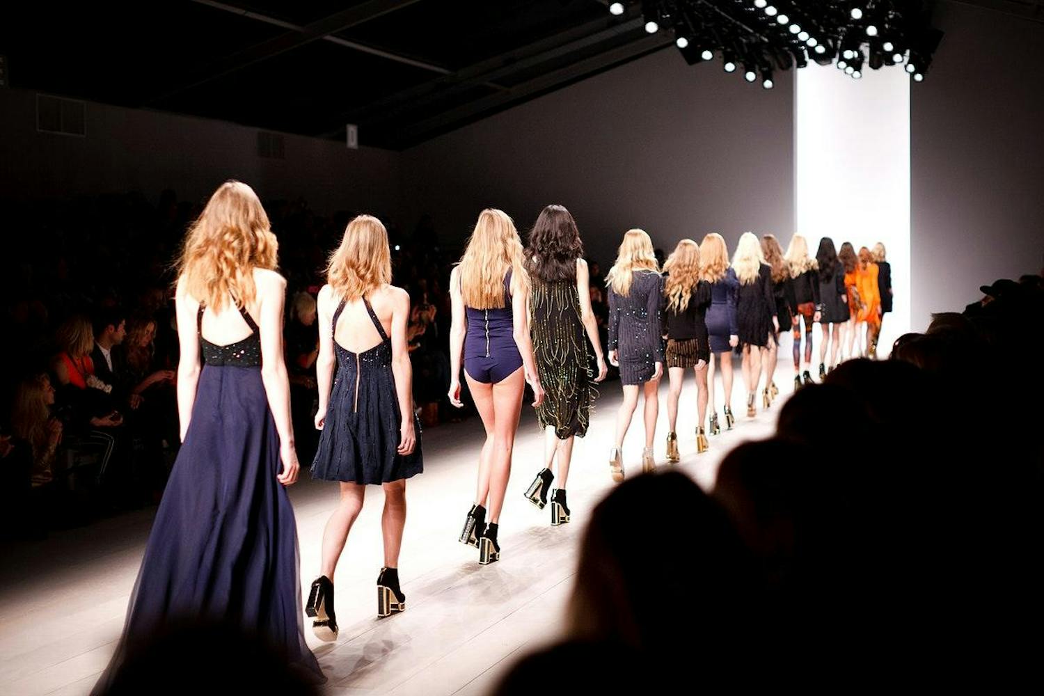A long line of models on the catwalk.