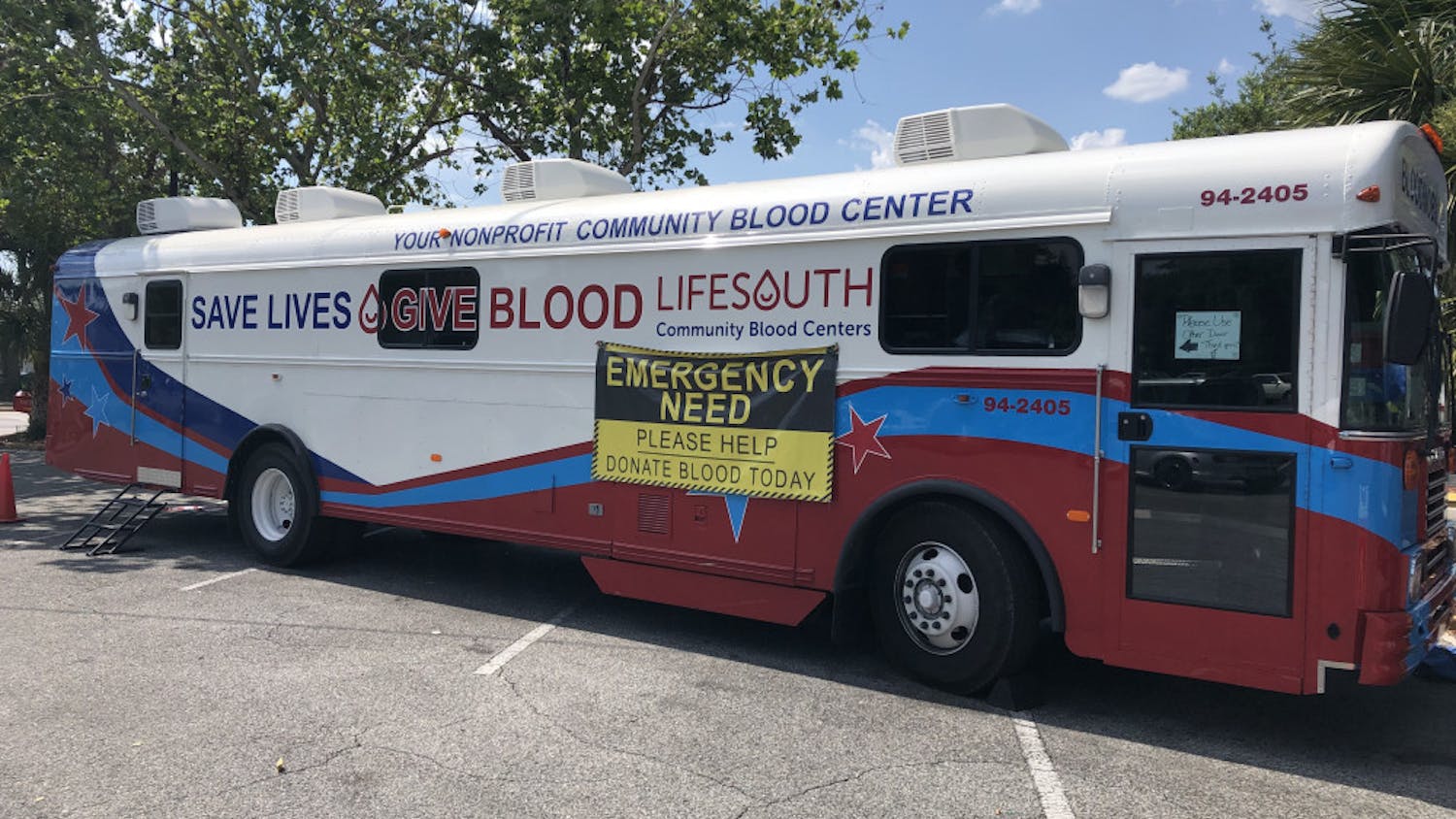 A LifeSouth blood mobile sits outside of the Publix at the West Gate Shopping Center. “Emergency need” signs have been added to all of their blood mobiles during the summer. Photo by Joseph Salvador