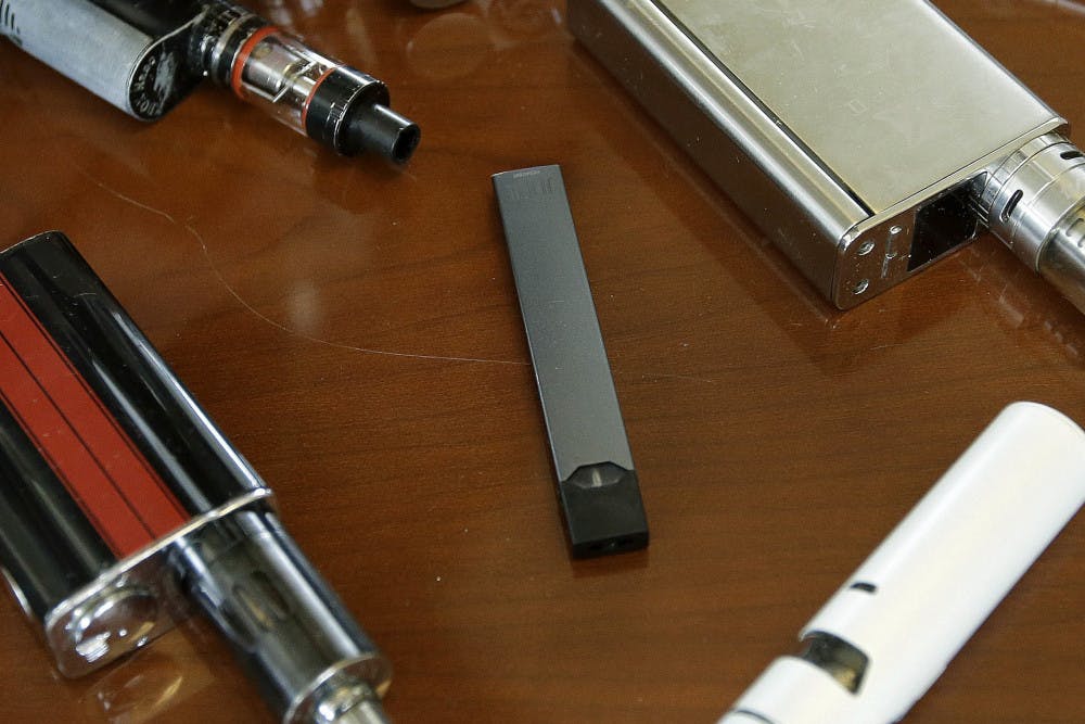<p>This Tuesday, April 10, 2018 file photo shows vaping devices, including a Juul, center, that were confiscated from students at a high school in Marshfield, Mass. On Tuesday, Nov. 13, 2018, San Francisco-based Juul Labs Inc. announced it had stopped filling orders for its mango, fruit, creme and cucumber pods but not menthol and mint. It will sell all flavors through its website and limit sales to those 21 and older. (AP Photo/Steven Senne)</p>