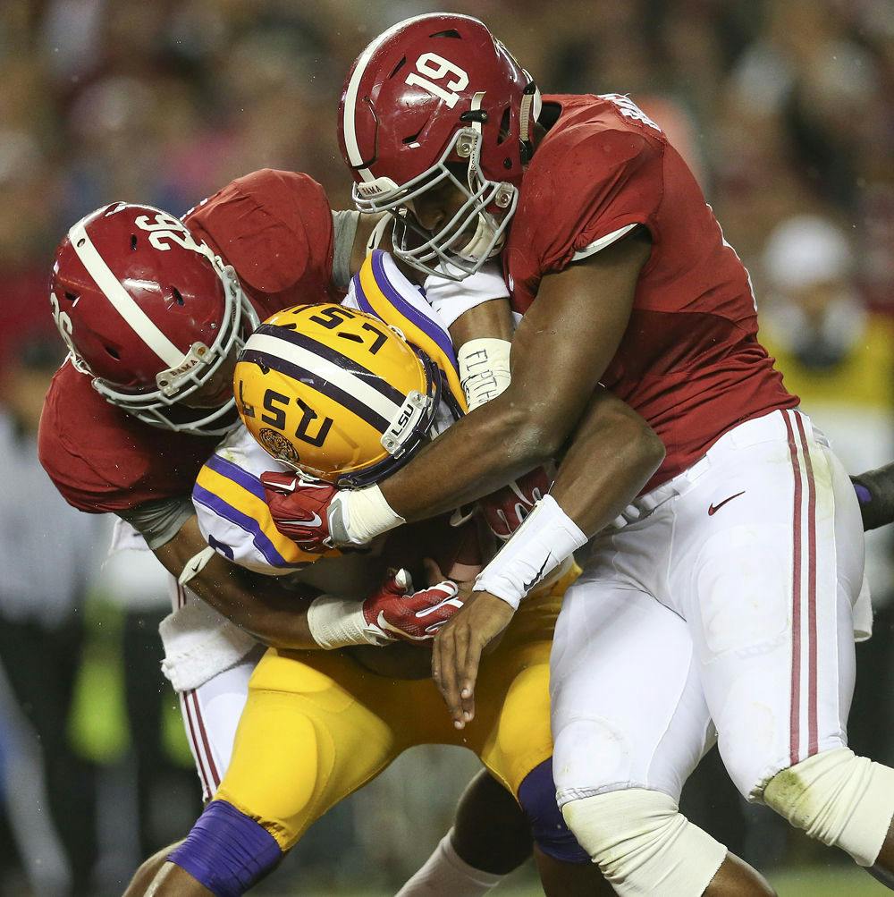 In this Nov. 7, 2015, file photo, LSU quarterback Brandon Harris (6) is hit by Alabama linebacker Reggie Ragland (19) and Alabama defensive back Marlon Humphrey (26) in the first half of an NCAA college football game, in Tuscaloosa , Ala.
