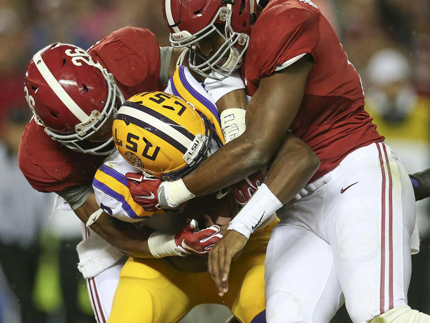 In this Nov. 7, 2015, file photo, LSU quarterback Brandon Harris (6) is hit by Alabama linebacker Reggie Ragland (19) and Alabama defensive back Marlon Humphrey (26) in the first half of an NCAA college football game, in Tuscaloosa , Ala.