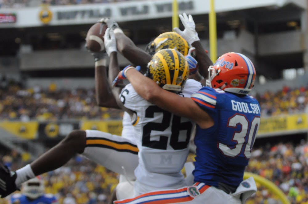 <p>Michigan's Jarrod Wilson intercepts a pass from UF quarterback Treon Harris in the endzone during the Wolverines' 41-7 win against the Gators in the Citrus Bowl on Jan. 1, 2016, in Orlando.</p>