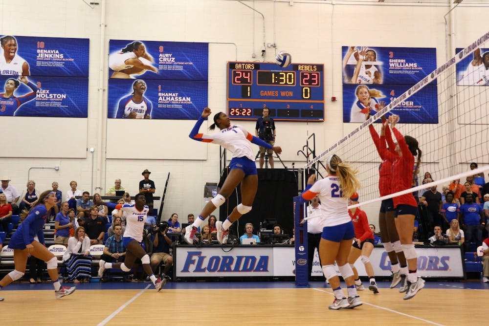 <p>Rhamat Alhassan (center) jumps for a kill during Florida's 3-0 win over Ole Miss on Oct. 28, 2016, in the Lemerand Center.</p>