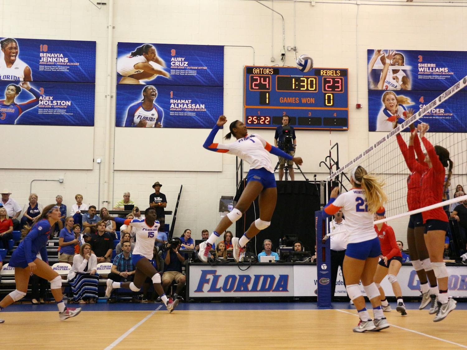 Rhamat Alhassan (center) jumps for a kill during Florida's 3-0 win over Ole Miss on Oct. 28, 2016, in the Lemerand Center.