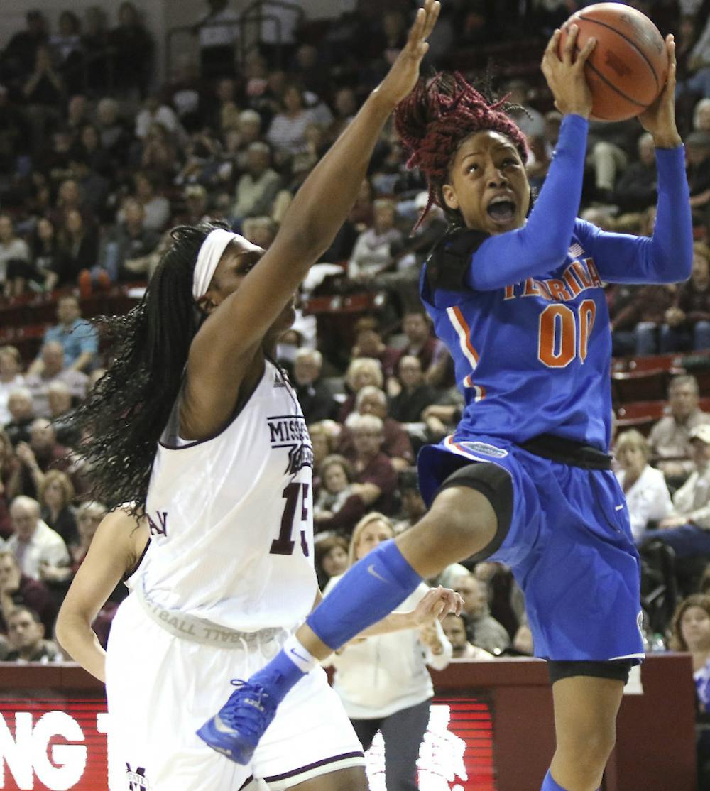 <p>Florida guard Delicia Washington (0) drives to the basket around Mississippi State center Teaira McCowan (15) during the second half of an NCAA college basketball game in Starkville, Miss., Thursday, Jan. 12, 2017. (AP Photo/Jim Lytle)</p>