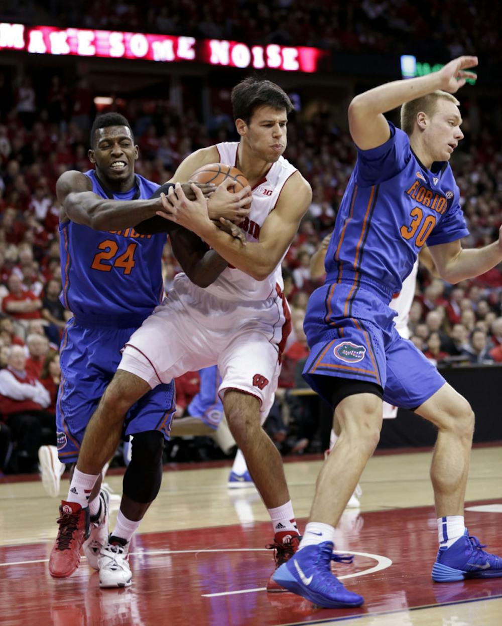 <p>Wisconsin’s Duje Dukan (center) grabs a rebound from Florida’s Casey Prather (left) and Jacob Kurtz during the Badgers’ 59-53 victory against the Gators in Madison, Wis., on Tuesday night.</p>