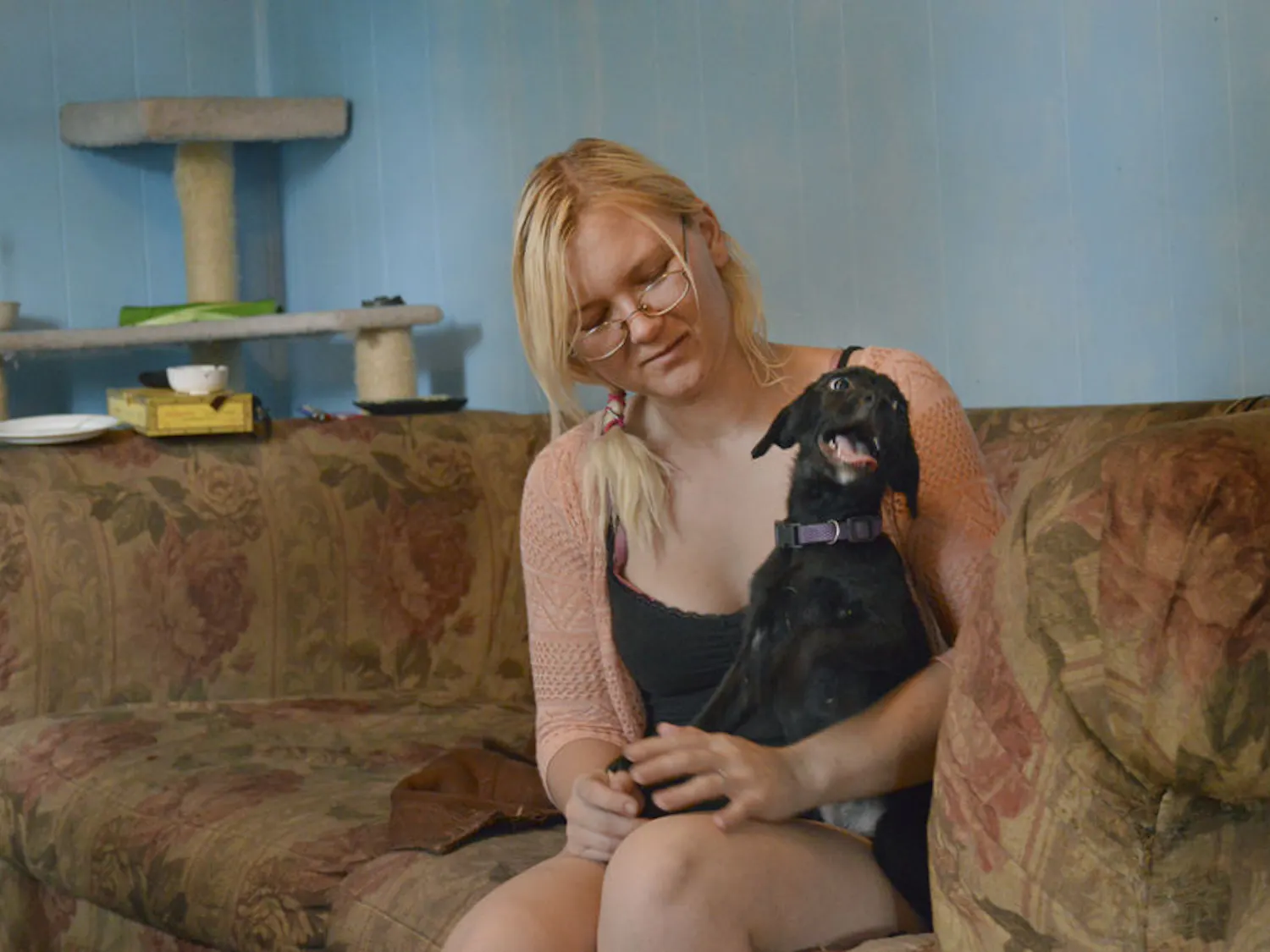 Rebecca Pardini plays in her home with Angel, a puppy she's taking care of for a friend. The 22-year-old was homeless for three years.