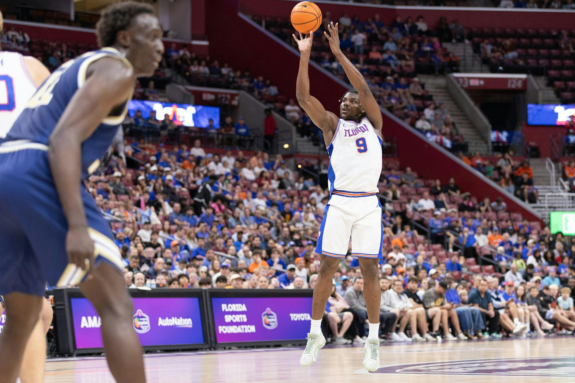 Florida Gators center Rueben Chinyelu (9) shoots during the AutoNation Orange Bowl Basketball Classic game against the George Washington Revolutionaries, Saturday, Dec. 13, at Amerant Bank Arena in Sunrise, Fla.