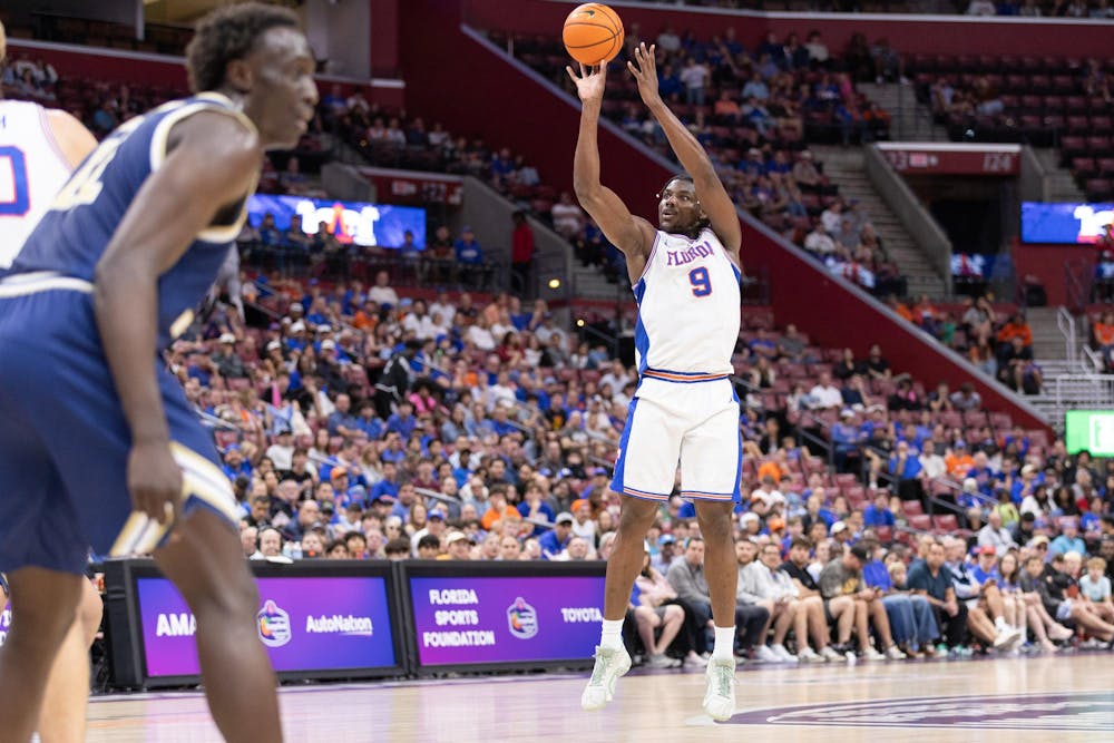 Florida Gators center Rueben Chinyelu (9) shoots during the AutoNation Orange Bowl Basketball Classic game against the George Washington Revolutionaries, Saturday, Dec. 13, at Amerant Bank Arena in Sunrise, Fla.