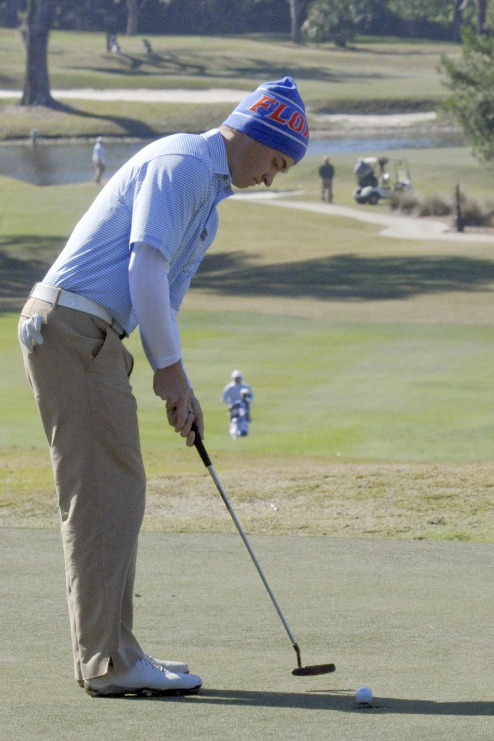 <p>Eric Banks putts during the first day of the SunTrust Gator Invitational on Feb. 14.</p>