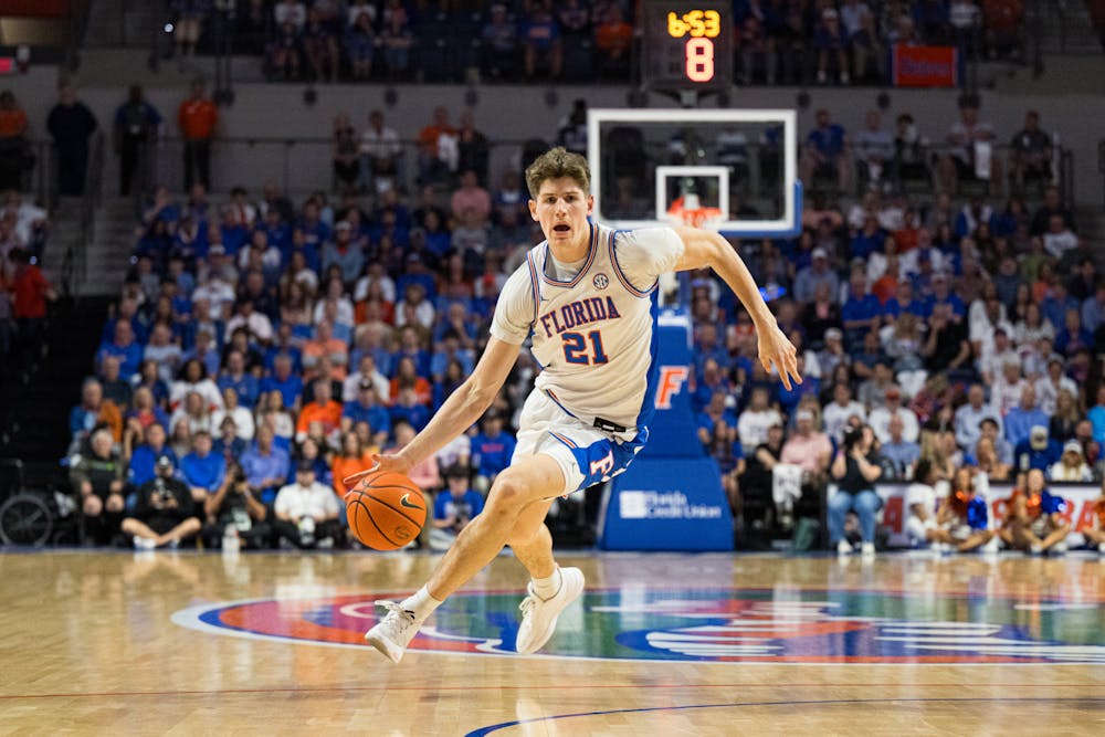 Florida Gators forward/center Alex Condon (21) dribbles the ball in a basketball game against Texas A&M on Saturday, Mar. 1, 2025, in Gainesville, Fla.