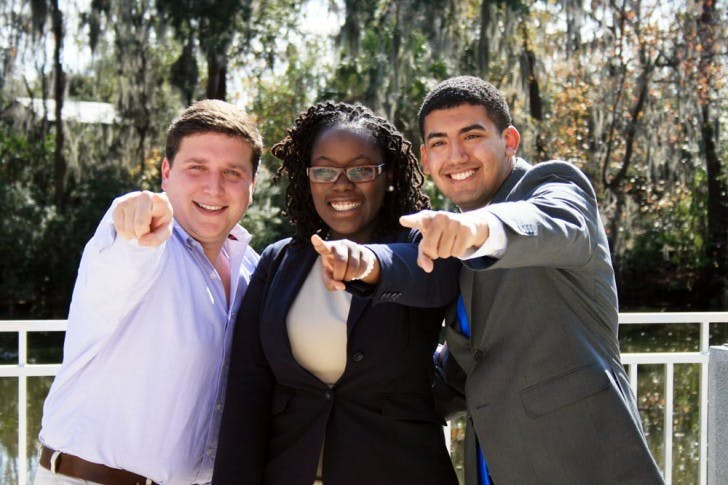 Tj Villamil, Sabine Justilien and Juan Rodriguez pose for another photographer at the Reitz Union Amphitheater on Wednesday afternoon. The three announced that they will be running together on the ballot for the Unite Party elections.